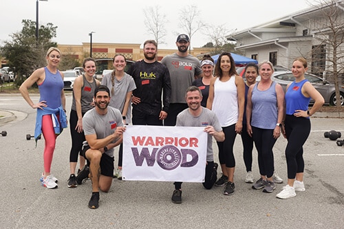 WarriorWOD Veterans recovering from Post Traumatic Stress holding a banner