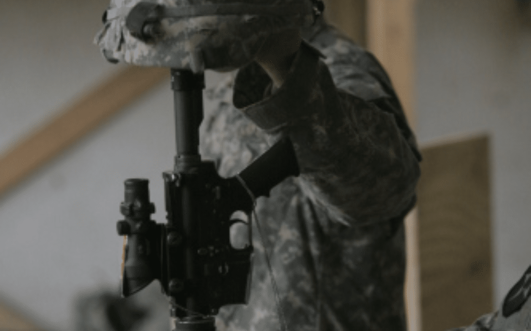 Everyday is Memorial Day. A soldier places a helmet on a rifle, symbolizing respect and remembrance for fallen comrades.