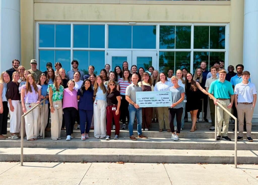 CSU physical therapy doctoral students present an $8,000 check to WarriorWOD Foundation after the 2026 Hustle for Heroes 5K at Charleston Southern University