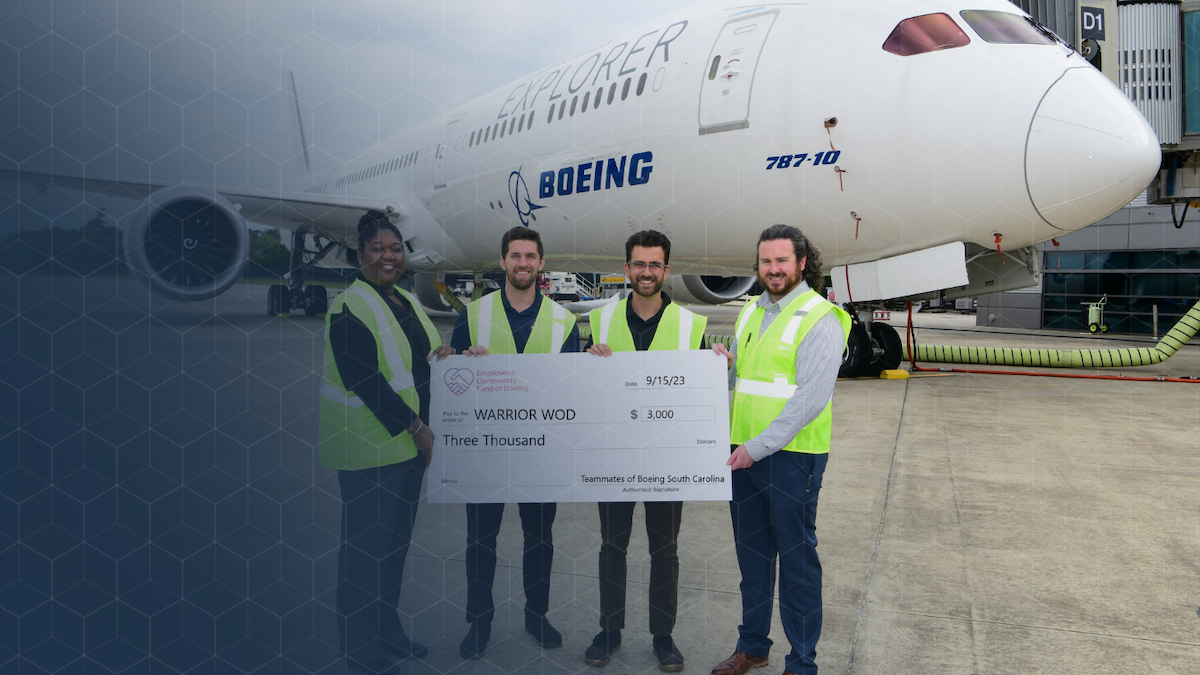 Boeing South Carolina employees present a $3,000 check to support a veteran PTSD recovery program at WarriorWOD