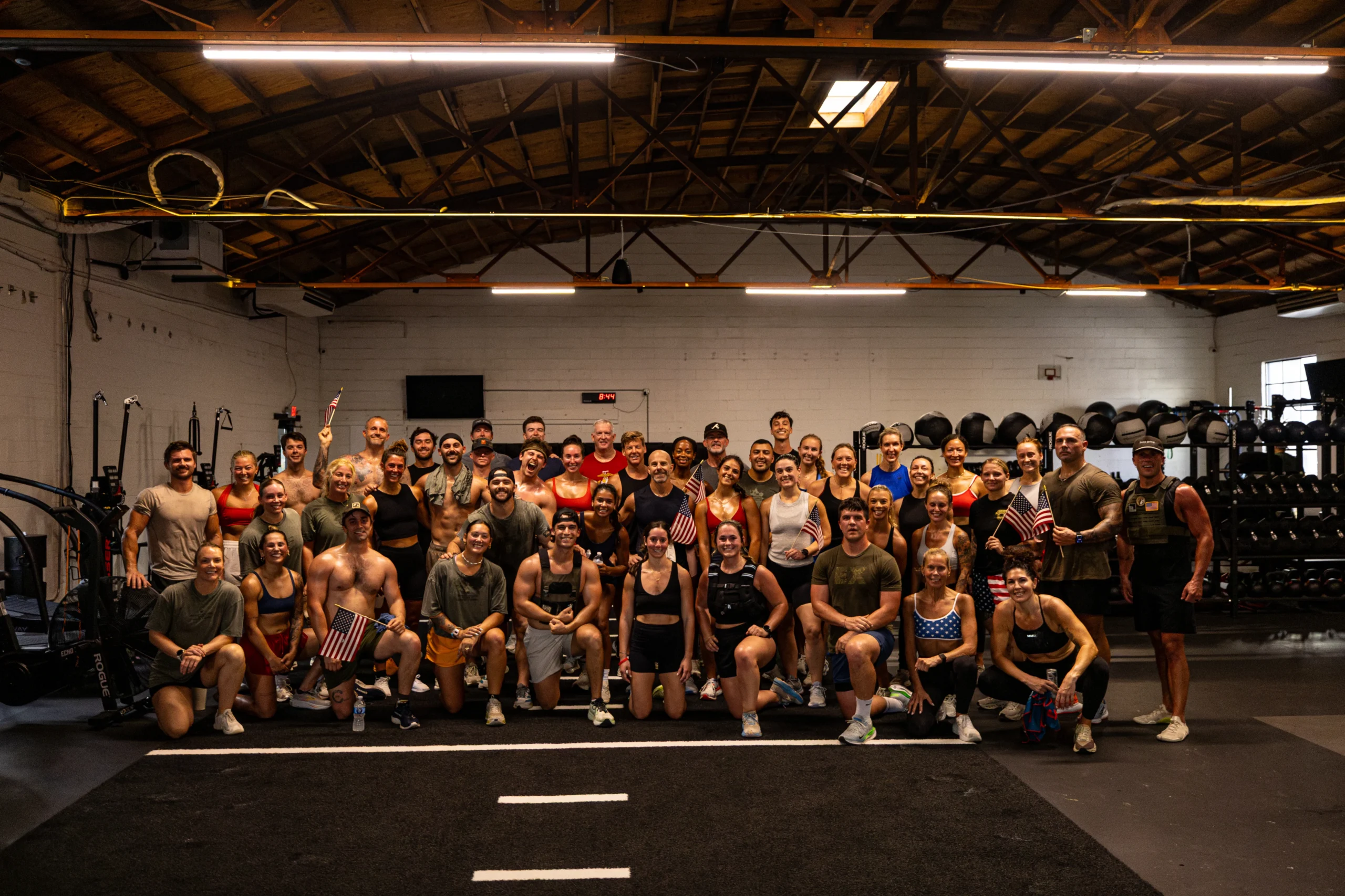More than 50 athletes with American flags after the 2026 Memorial Day Murph at Ethos Athletic Club in Charleston