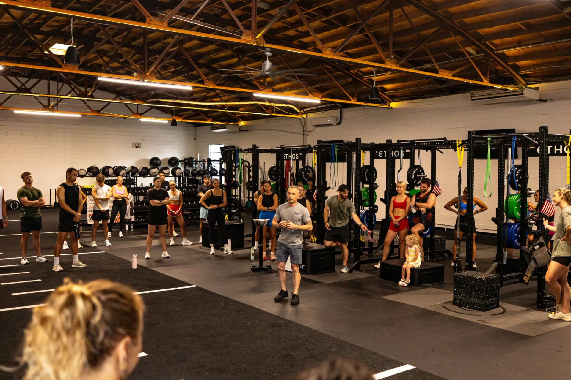 WarriorWOD CEO and Founder Phil Palmer in a No One Fights Alone shirt briefing athletes before Memorial Day Murph at Ethos